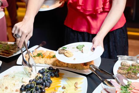 People at a banquet taking different food.の写真素材