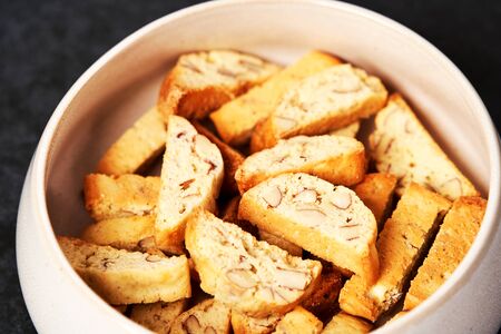 Sweet cookies with nuts on white bowl. Healthy snack - cracker with nutの写真素材