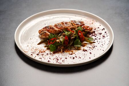 Spicy chicken breast with minted green beans, close-up.