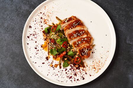 Spicy chicken breast with minted green beans, close-up. Grilled chicken fillet and baked green...
