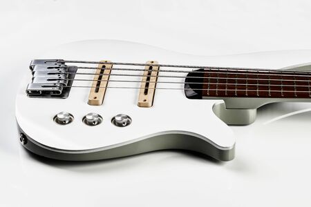 White bass guitar details on a white background with copy space. White Electric Bass Guitar strings,...
