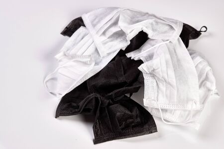 Utilized medical mask on a white background with copy space, close-up. Surgical Ear-Loop Masks.