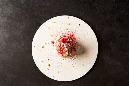 Meringue dessert Pavlova cake with fresh raspberries and whipped cream. French dessert. Muffin with mascarpone cheese on gray background with copy space, close-up. Luxury restaurant foodの写真素材