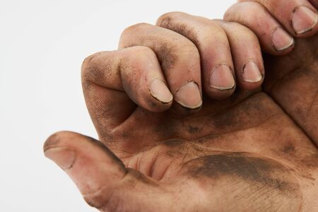 Dirty hand isolated on a white background with copy space. Man show his dirty hands with palms,  close-upの写真素材