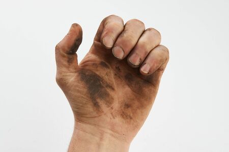 Dirty hand isolated on a white background with copy space. Man show his dirty hands with palms,  close-upの写真素材