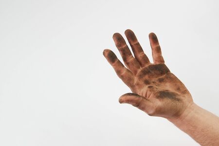 Dirty hand isolated on a white background with copy space. Man show his dirty hands with palms,  close-upの写真素材
