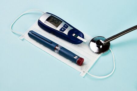 Coronavirus poses greatest risk for diabetes. Insulin pen, diabetic syringe, blood sugar test and...