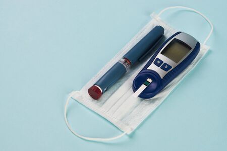 Coronavirus poses greatest risk for diabetes. Insulin pen, diabetic syringe, blood sugar test and...