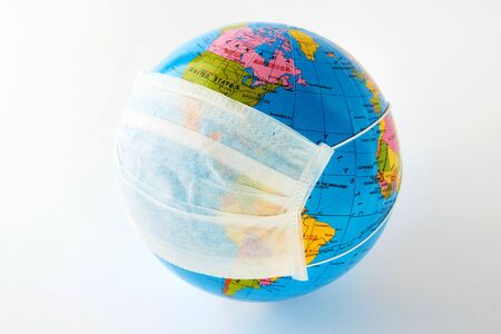 Coronavirus pandemic on world globe. World coronavirus disease. Planet Earth with medical mask. Global pandemicの写真素材