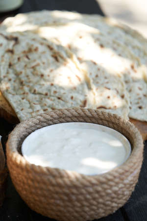 Azerbaijani traditional cuisine - Kutabs or Gozleme with herbs or meat. Breakfast table with kutab...