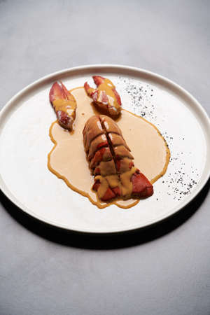 Seafood lobster with soup sauce. Keto diet food - Cooked lobster on restaurant table, close-up