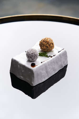 Fried cheese balls with nuts and spices. Snack cheese balls serving on decorative tray. Luxury restaurant food tableの写真素材