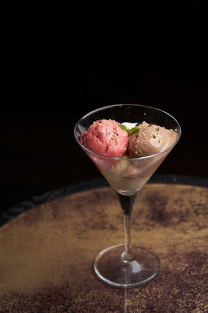 Sundae ice cream in glass.  Chocolate ice cream balls on restaurant table
