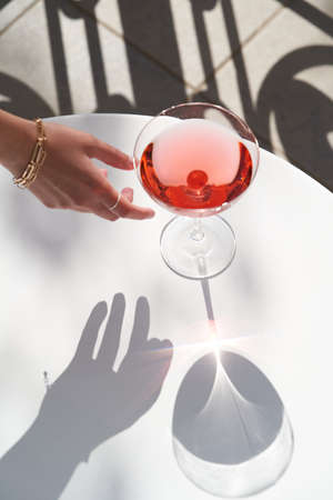 Red cocktail in martini glass with cherry. Exotic alcoholic cocktail on table