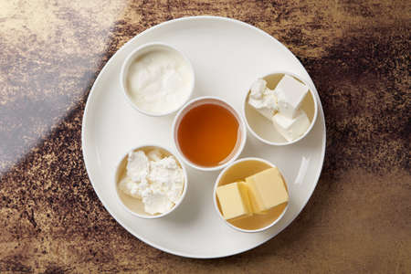 Healthy breakfast set on table with honey, tea, bread and butter