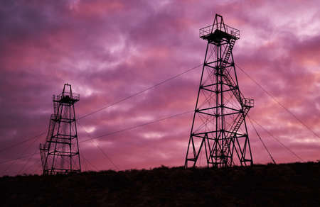 Abandoned oil rig with dramatic sky clouds. Oil industry towerの写真素材
