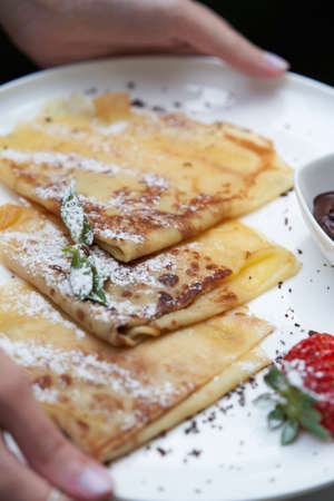 Healthy breakfast table with Crepes, blueberries, strawberry and yoghurt. Pancakes with fresh berries and jamの写真素材