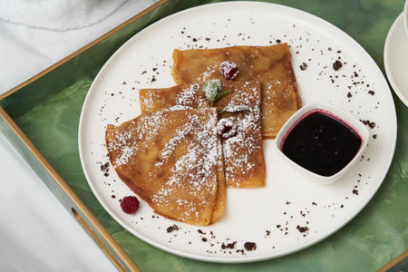 Hotel breakfast in bed. Hotel service breakfast with fresh juice, porridge and pancakeの写真素材