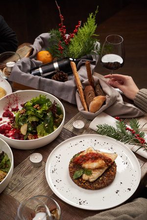 Christmas dinner. Happy couple celebrating Christmas at festive table with food and drinks