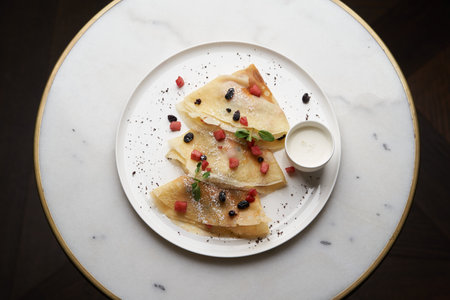 Crepes, apple pancake or caramelized apple crepe with yoghurt cream. Homemade pancake breakfast on...