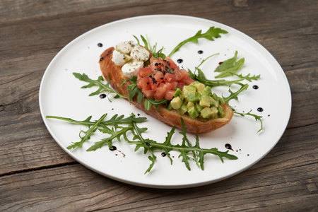 Healthy vegetarian bruschetta with vegetable and cheese. Vegetarian sandwiches on white plate on tableの写真素材
