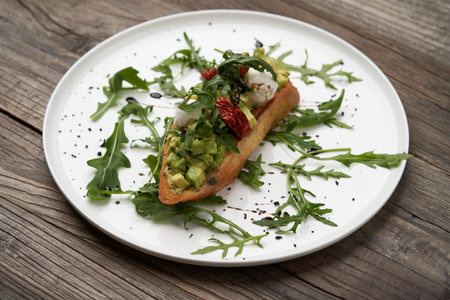Healthy vegetarian bruschetta with vegetable and cheese. Vegetarian sandwiches on white plate on...