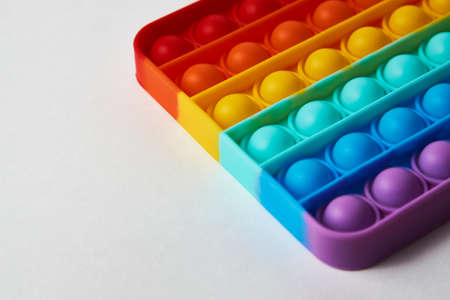 Multicolor poppit toy on a white background, close-up. Colorful popp it game. Silicone Tie-dye Push pop Bubbleの写真素材