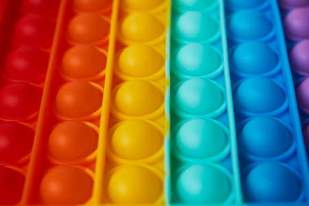 Multicolor poppit toy on a white background, close-up. Colorful popp it game. Silicone Tie-dye Push pop Bubbleの写真素材