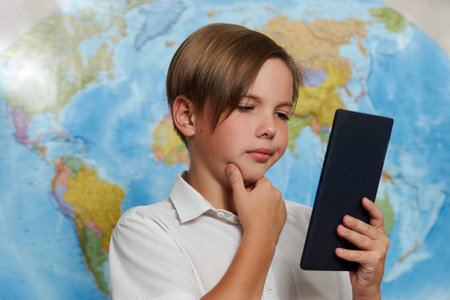 Portrait of a school boy using digital tablet. E-learning and online education concept.