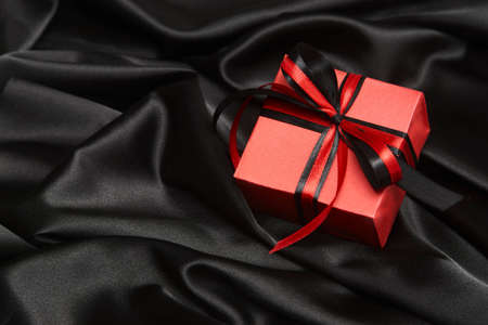 Christmas gift box with ribbon on silk background with copy space, close-upの写真素材