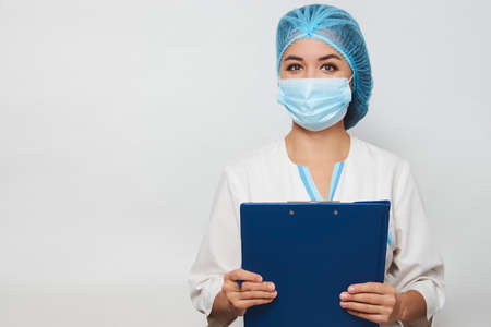 Female doctor holding clipboard and writing something close up. Medical healthcare, insurance,...