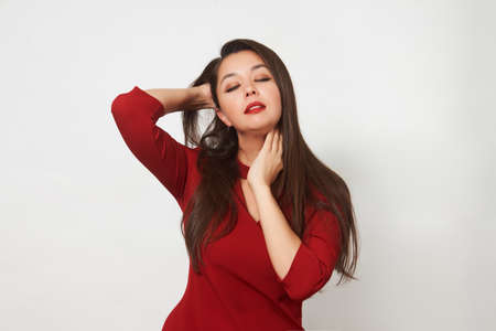 Beautiful young woman in black shirt on a white background with copy space. Portrait of asian girl...