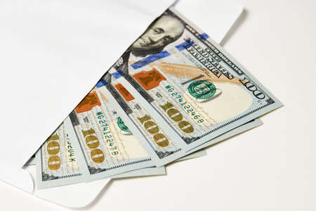 Dollar money in an envelope isolated on white. Envelope with money. Dollar bills. Salary, earning and savings conceptの写真素材
