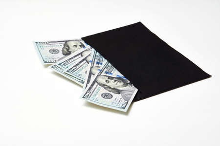 Black Envelope with money, csloe-up. Dollar money in an envelope isolated on white. Salary, earning and savings conceptの写真素材