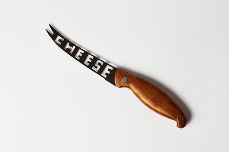 Cheese knife isolated on a white background with copy space, close-upの写真素材