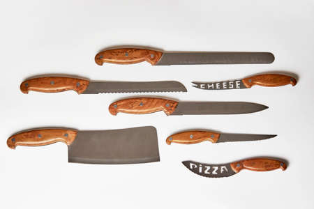 Kitchen knives on white background. Set of steel knives with wooden handle