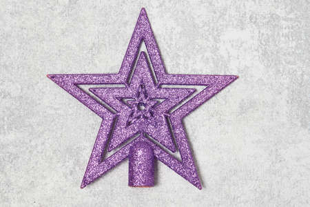 Christmas tree star on gray background. Happy new year and Christmas decoration.
