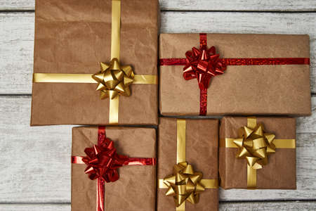 Christmas Gift boxes wrapped in craft paper on wooden background with copy space
