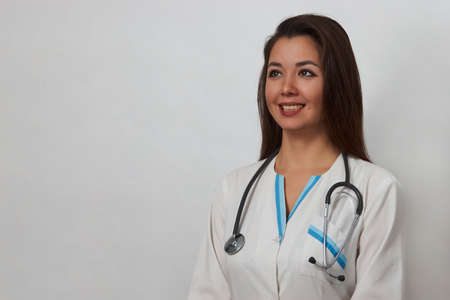 Portrait of woman doctor with stethoscope. Female doctor medical coat on white background with copy spaceの写真素材