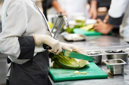 Chef cooking food in restaurant kitchen, close-up. Cook hands preparing breakfastの写真素材