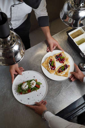 Crepes served with fresh berries and apples. Breakfast menu, traditional pancakes on a white plate