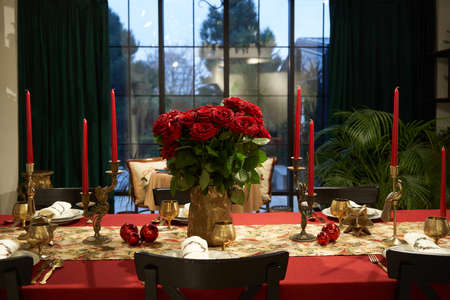 Beautiful table setting with Christmas decorations. Christmas dinner table with window on backgroundの写真素材