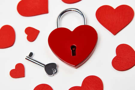 Valentines day background with red heart shaped lock and key. Love symbol heart padlockの写真素材