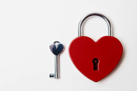 Valentines day background with red heart shaped lock and key. Love symbol heart padlockの写真素材