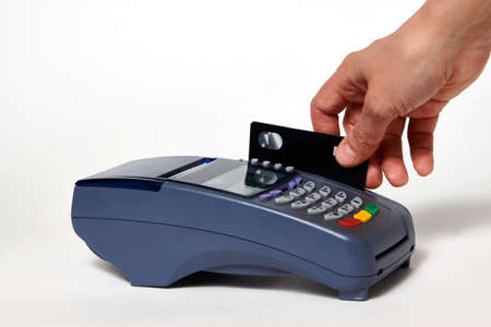 Credit card payment, buy and sell service. Woman hand with credit card and payment terminal on white...