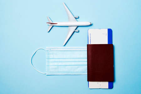 Traveling during pandemic. Passport, protective face mask and plane. virus and travel conceptの写真素材