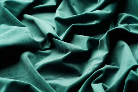 Green fabric background, view from above. Smooth elegant green luxury cloth texture can use as abstract background with copy space, close-upの写真素材
