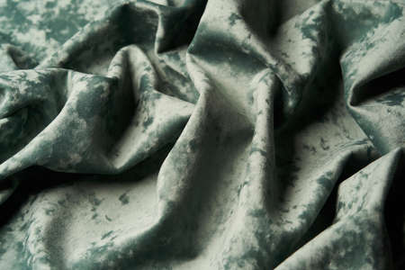 Green fabric background, view from above. Smooth elegant green luxury cloth texture can use as...