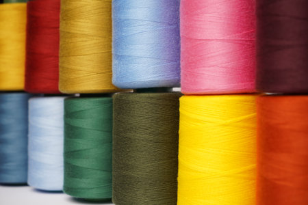 Colorful thread spool background, close-up. Multi Colored threads for sewing and needlework
