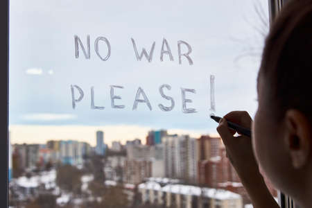 No war please, woman writing on window glass, close-upの写真素材